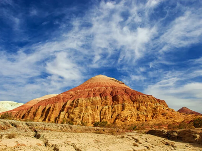 Red and yellow Aktau mountains under a blue sky in Altyn Emel