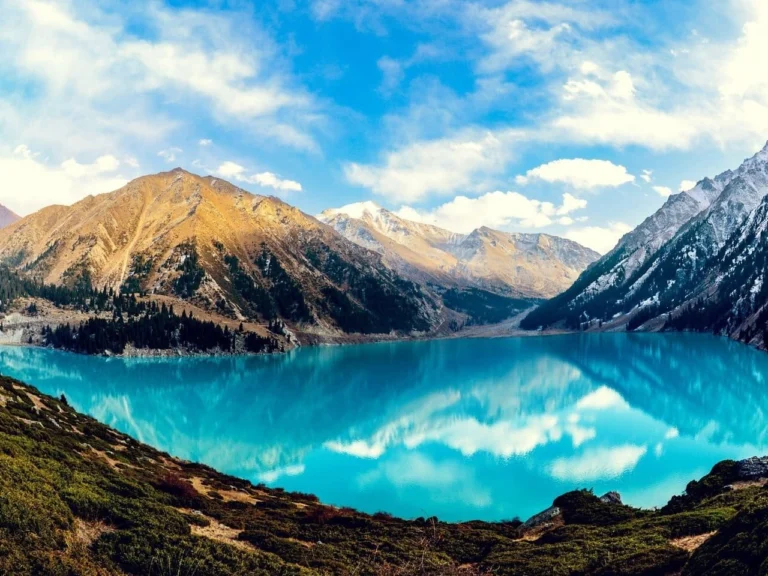 Turquoise water of Big Almaty Lake ringed by mountains