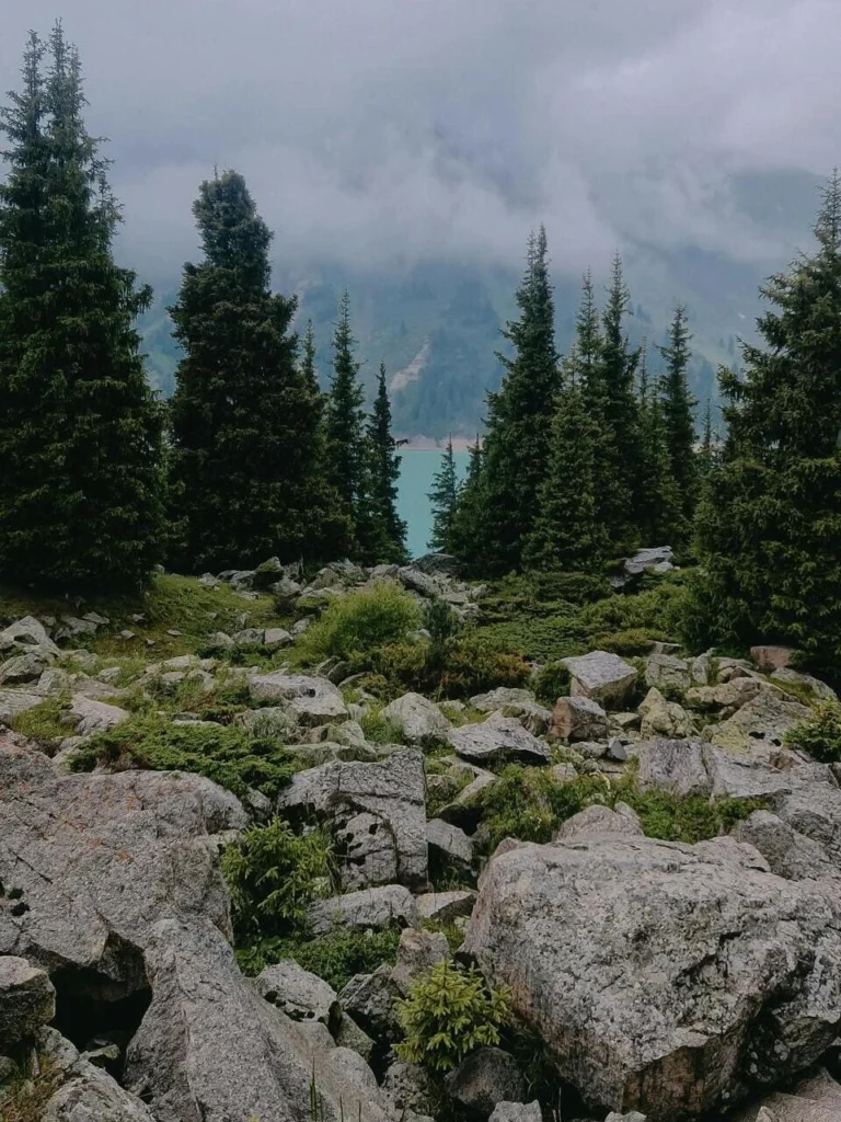 Calm morning at Issyk Lake with mist over the mountain peaks