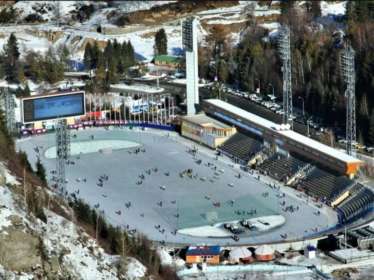 The Medeo high-altitude ice rink surrounded by snowy mountains above Almaty