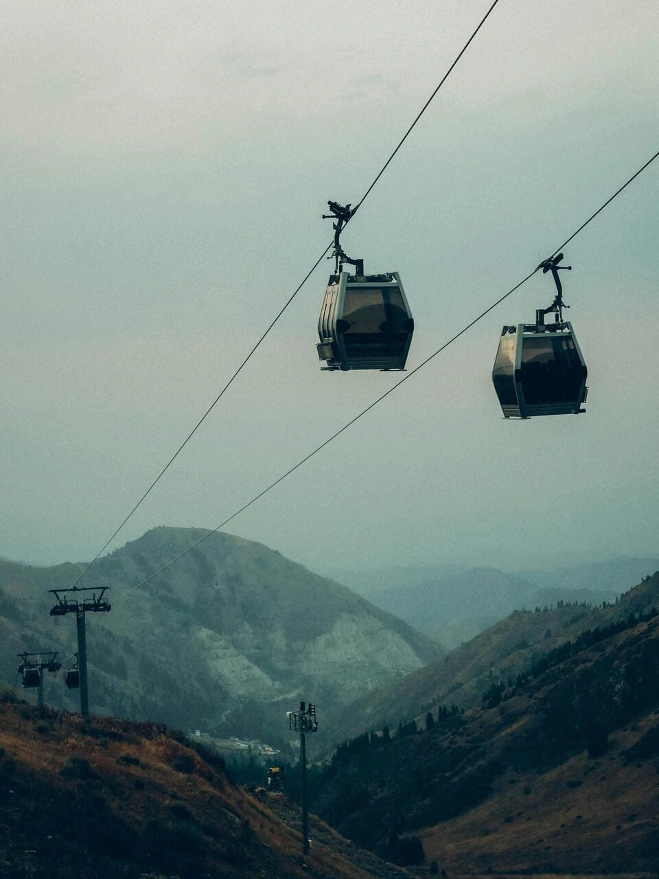 Shymbulak Ski Resort Tour 1 gondola cable cars at shymbulak ski resort moving over mountain valley in kazakhstan